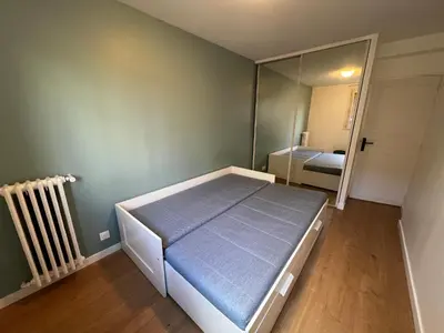 Un ou plusieurs lits dans un hébergement de l'établissement Appartement Paris 19