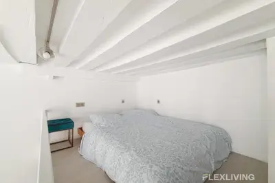 Un ou plusieurs lits dans un hébergement de l'établissement Charmant studio dans Paris 04ème