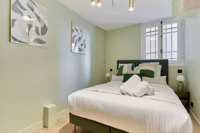 Un ou plusieurs lits dans un hébergement de l'établissement Grand Duplex - Arc de Triomphe