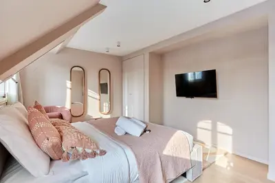 Un ou plusieurs lits dans un hébergement de l'établissement Grand Duplex - Arc de Triomphe