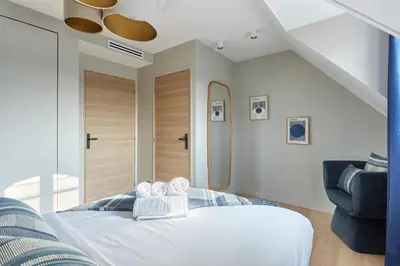 Un ou plusieurs lits dans un hébergement de l'établissement Grand Duplex - Arc de Triomphe