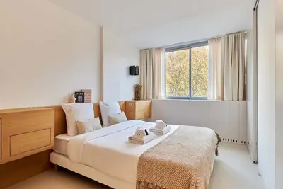 Un ou plusieurs lits dans un hébergement de l'établissement Sublim apartment Montaigne-Eiffel Tower