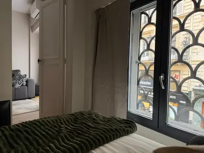 Un ou plusieurs lits dans un hébergement de l'établissement Charmant appartement avec chambre cosy et canapé convertible