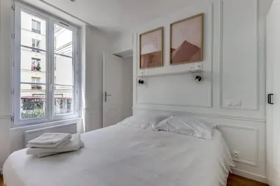 Un ou plusieurs lits dans un hébergement de l'établissement Bel appartement au coeur de Paris