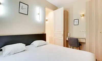 Un ou plusieurs lits dans un hébergement de l'établissement Magnifique Appartement - 3 BR-Arc de Triomphe