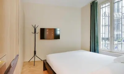 Un ou plusieurs lits dans un hébergement de l'établissement Magnifique Appartement - 3 BR-Arc de Triomphe