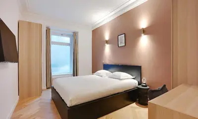 Un ou plusieurs lits dans un hébergement de l'établissement Magnifique Appartement - 3 BR-Arc de Triomphe