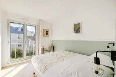 Un ou plusieurs lits dans un hébergement de l'établissement Spacious parisian apartment - 2BR 4P – République