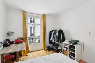 Un ou plusieurs lits dans un hébergement de l'établissement Charmant appartement pour 4 à Paris