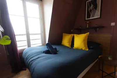 Un ou plusieurs lits dans un hébergement de l'établissement APPARTEMENT CHALEUREUX ARTISTIQUE QUARTIER GARE DU NORD - GARE DE L'EST et GRANDS BOULEVARDS