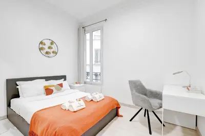 Un ou plusieurs lits dans un hébergement de l'établissement Suite Magenta - Opulence au cœur de Paris