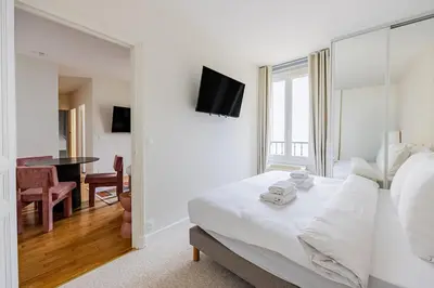 Un ou plusieurs lits dans un hébergement de l'établissement #4people#1Bedroom#ChampsElysées#AC