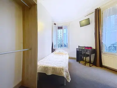 Un ou plusieurs lits dans un hébergement de l'établissement Au Fleuri hotel