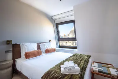 Un ou plusieurs lits dans un hébergement de l'établissement Sublime appartement Arc de Triomphe