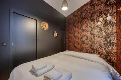 Un ou plusieurs lits dans un hébergement de l'établissement Charming Loft 2p Montmartre Joffrin