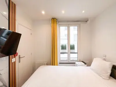 Un ou plusieurs lits dans un hébergement de l'établissement UrbanFlat 115 - Grand Duplex dans le centre de Paris