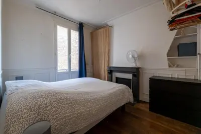Un ou plusieurs lits dans un hébergement de l'établissement Appartement proche Sacré Coeur Paris 18