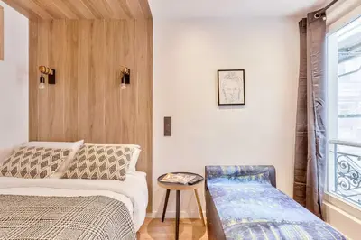 Un ou plusieurs lits dans un hébergement de l'établissement UrbanFlat 103 - Grand appartement - Grands Boulevards
