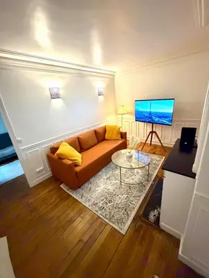Télévision ou salle de divertissement dans l'établissement YZY LOC Paris Moulin-Rouge