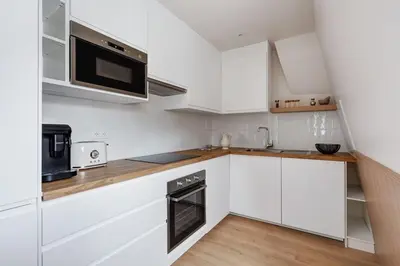 Cuisine ou kitchenette dans l'établissement Saint Placide VI Suite