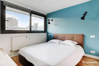Un ou plusieurs lits dans un hébergement de l'établissement Cozy apartment - 1BR 4P - next to Paris