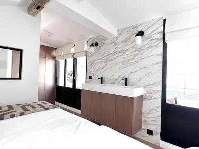 Un ou plusieurs lits dans un hébergement de l'établissement Duplex elegant au coeur du Marais avec cinema - 6P