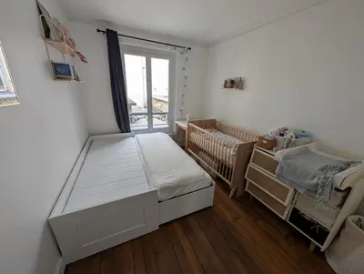 Un ou plusieurs lits dans un hébergement de l'établissement Quiet family apartment in Paris Near 7 metro lines