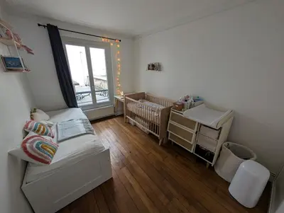 Un ou plusieurs lits dans un hébergement de l'établissement Quiet family apartment in Paris Near 7 metro lines