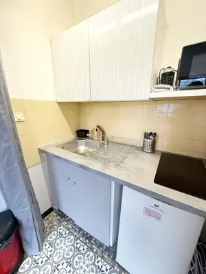 Cuisine ou kitchenette dans l'établissement Cozy Studio for 2 Pax - 10 min from La Défense Paris Arena