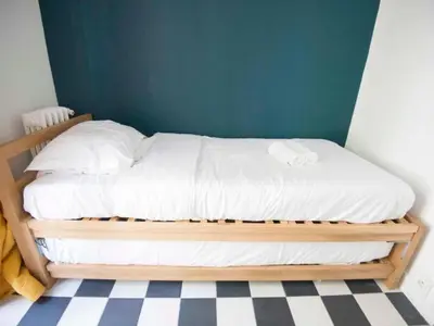 Un ou plusieurs lits dans un hébergement de l'établissement Apartment Zimmer mit Badezimmer by Interhome