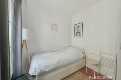 Un ou plusieurs lits dans un hébergement de l'établissement Studio 5min Gare de lEst quartier animé & culturel