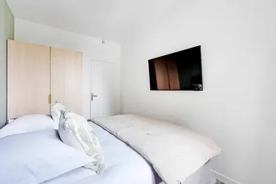 Un ou plusieurs lits dans un hébergement de l'établissement Cozy Apartment 1BR-3P - Ivry