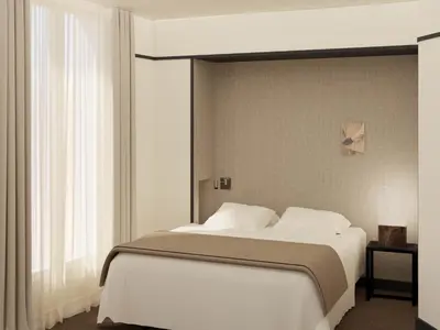 Un ou plusieurs lits dans un hébergement de l'établissement Hôtel Atlas