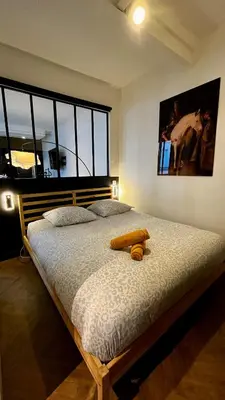 Un ou plusieurs lits dans un hébergement de l'établissement Appartement élégant à cœur de Paris 2ème