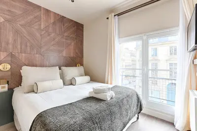 Un ou plusieurs lits dans un hébergement de l'établissement Sublime appartement Rue Royale