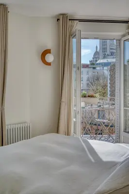 Un ou plusieurs lits dans un hébergement de l'établissement Appartement Lamarck Luxury