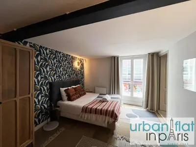 Un ou plusieurs lits dans un hébergement de l'établissement UrbanFlat 161 - Grand Appartement Central Rue de Paradis