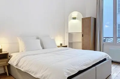 Un ou plusieurs lits dans un hébergement de l'établissement Superbe Appartements Bourdonnais Tour Eiffel