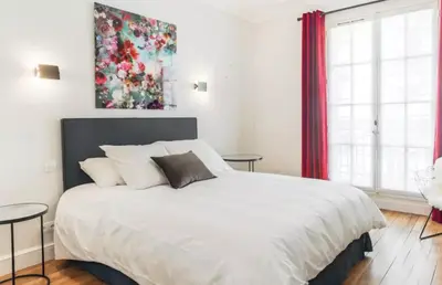Un ou plusieurs lits dans un hébergement de l'établissement Superbe Appartements Louvre Richelieu