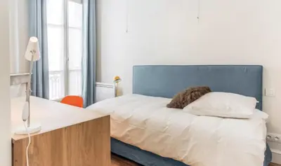 Un ou plusieurs lits dans un hébergement de l'établissement Superbe Appartements Louvre Richelieu