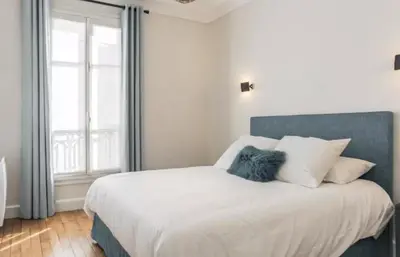 Un ou plusieurs lits dans un hébergement de l'établissement Superbe Appartements Louvre Richelieu
