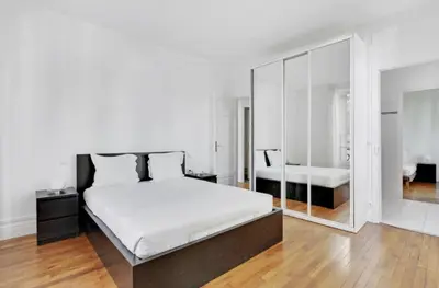 Un ou plusieurs lits dans un hébergement de l'établissement Superbe Appartements Tour Eiffel Suffren