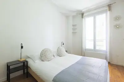 Un ou plusieurs lits dans un hébergement de l'établissement Cozy Apartment - 1BDR 2P - Montparnasse