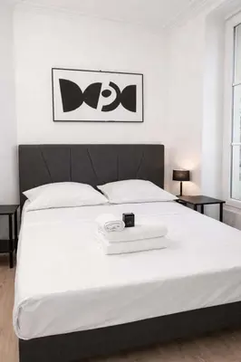Un ou plusieurs lits dans un hébergement de l'établissement Studio Parisien grands boulevards Couple ou Solo