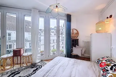 Un ou plusieurs lits dans un hébergement de l'établissement Appartement cosy avec vue sur le Sacré-Cœur
