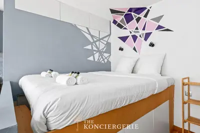 Un ou plusieurs lits dans un hébergement de l'établissement Appartement design & confortable avec terasse