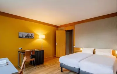Un ou plusieurs lits dans un hébergement de l'établissement Aparthotel Adagio Paris XV