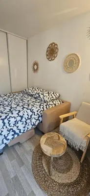 Un ou plusieurs lits dans un hébergement de l'établissement Une chambre douillette à Stade de France
