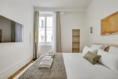 Un ou plusieurs lits dans un hébergement de l'établissement Pick A Flat's Apartment in Louvre - Rue Coquillère