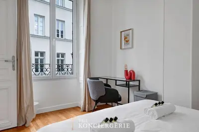 Un ou plusieurs lits dans un hébergement de l'établissement Appartement avec 3 chambres dans le Marais